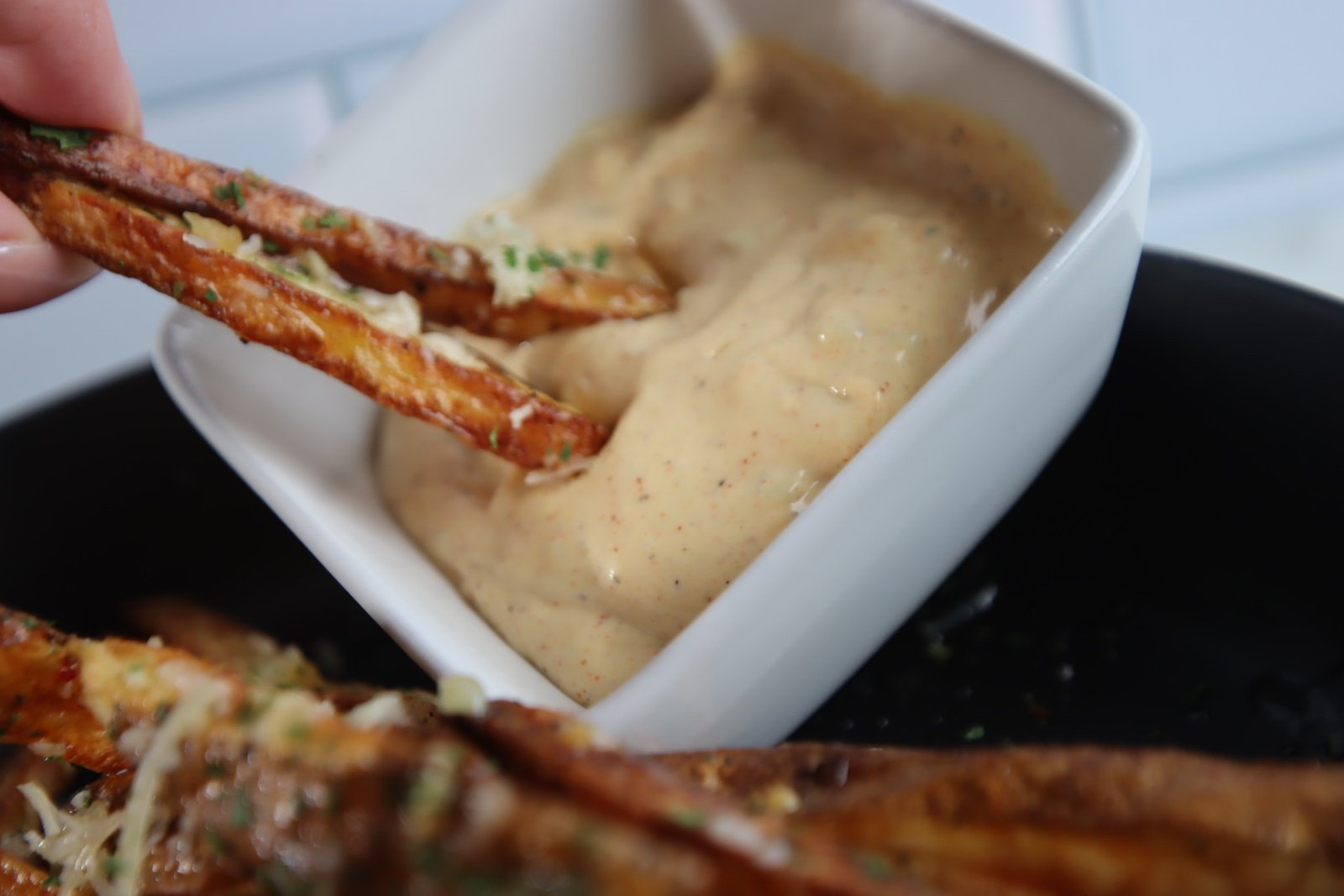Fries dipped in mac sauce